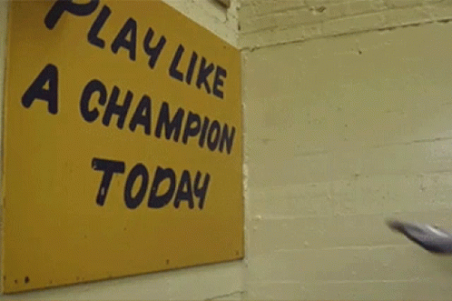 Football Player in Front of Play We a Champion Today Sign