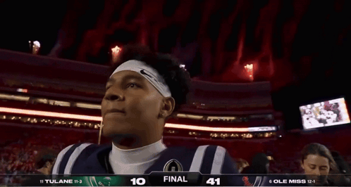 Football Player in Front of Scoreboard Saying Final