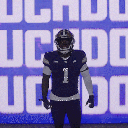 Football Player in Front of UC Logo