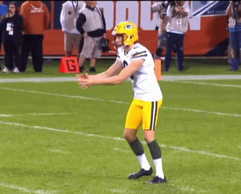 Football Player in Green Bay Packers Helmet on Field