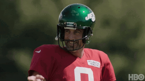 Football Player in Green Helmet and Red Jersey