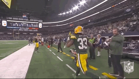 Football Player in Green Jersey Number 33 Running