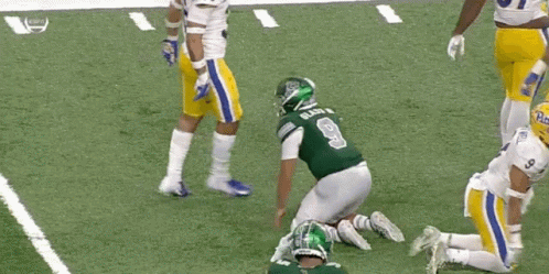 Football Player in Green Jersey Number 9 Kneeling
