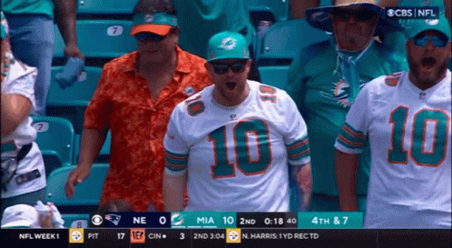Football Player In Helmet And Gloves Covering Mouth GIF