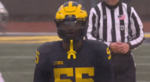 Football Player in Helmet and Jersey Number 25