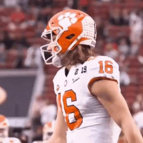 Football Player in Helmet and White Jersey Number 16