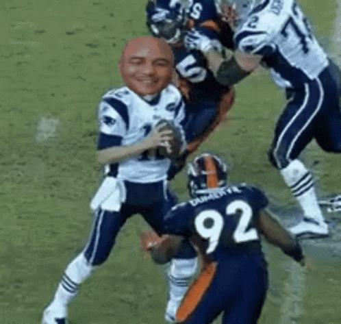 Football Player in Jersey 92 Tackled by Another