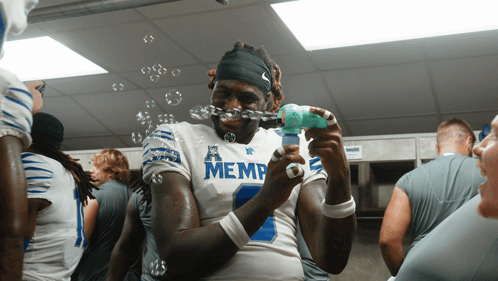 Football Player in Memphis Jersey Blowing Bubbles