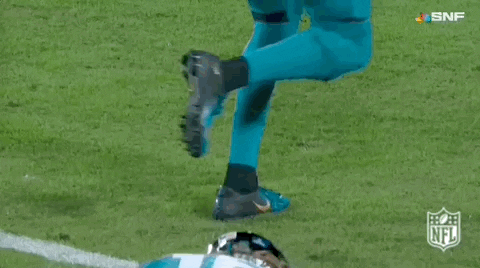 Football Player in Number 16 Jersey Lying on Field