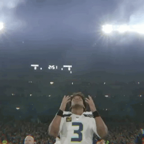 Football Player in Number 3 Jersey in Front of Scoreboard