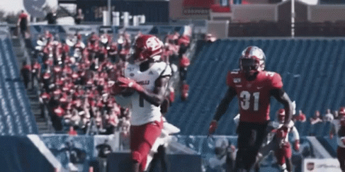 Football Player in Number 31 Jersey Catching Ball