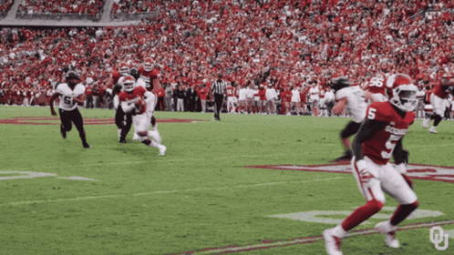 Football Player in Number 5 Jersey Running
