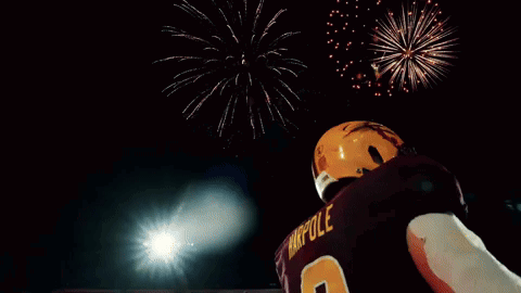 Football Player in Number 9 Jersey With Fireworks
