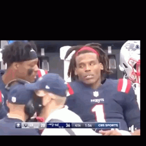 Football Player in Patriots Jersey Talking to Coach
