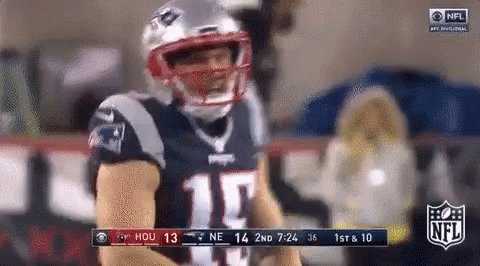 Football Player in Patriots Uniform on Sidelines