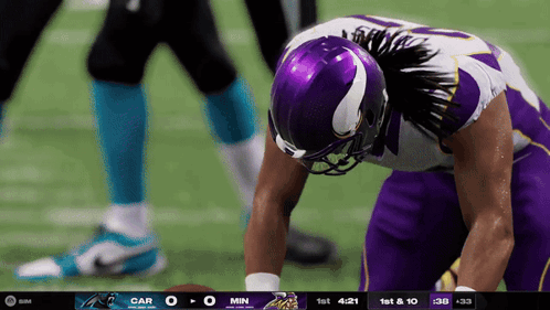 Football Player in Purple Helmet Looking Down