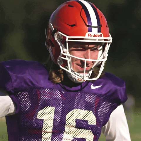 Football Player in Purple Jersey and Red Riddell Helmet