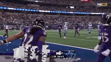 Football Player in Purple Uniform Celebrating Touchdown