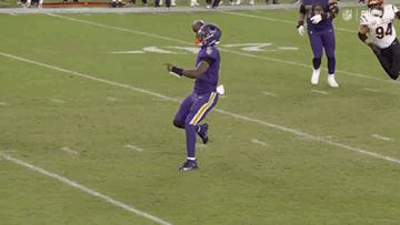 Football Player in Purple Uniform Jumping