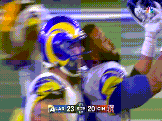 Football Player in Rams Helmet Catching Ball