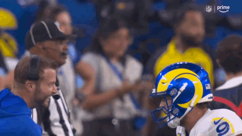 Football Player in Rams Helmet Talking to Referee