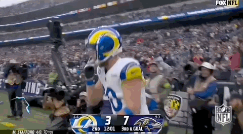 Football Player in Rams Uniform Celebrating Touchdown Against Ravens