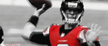 Football Player in Red and Black Uniform Throwing Football