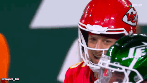 Football Player in Red and Green Helmet With Jets