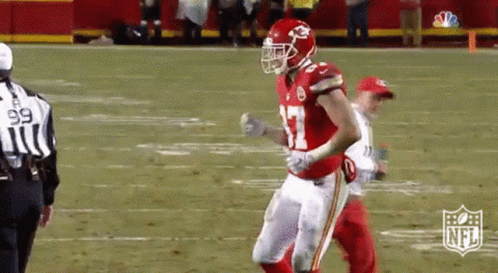 Football Player in Red Helmet and White Pants Running