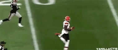 Football Player in Red Helmet Running to End Zone