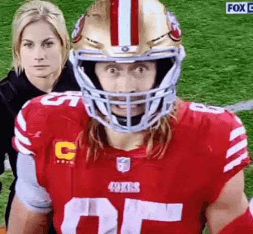 Football Player in Red Jersey and Helmet on Field