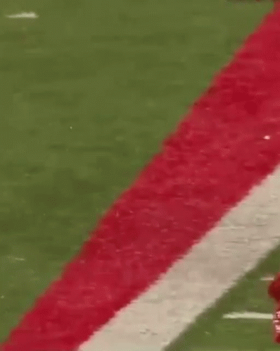 Football Player in Red Jersey Number 20 Running
