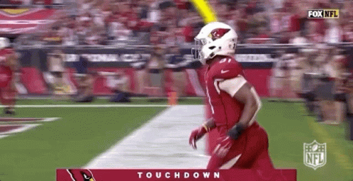 Football Player in Red Uniform Running Down Field