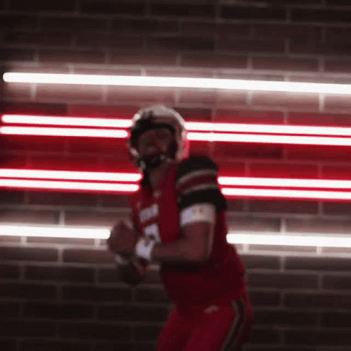 Football Player in Red Uniform Running With Ball