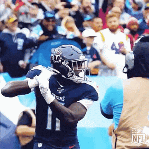 Football Player in Titans Jersey Running with Ball