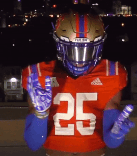 Football Player in Tulsa Helmet and Gloves