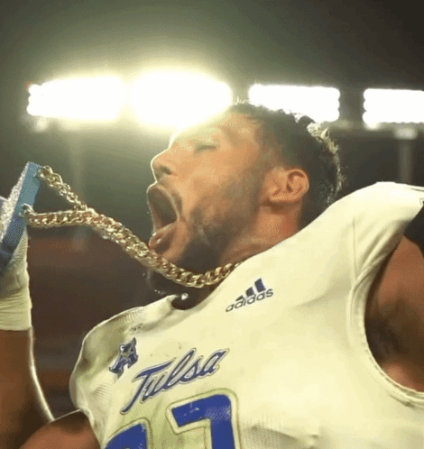 Football Player in Tulsa Jersey Holding Chain