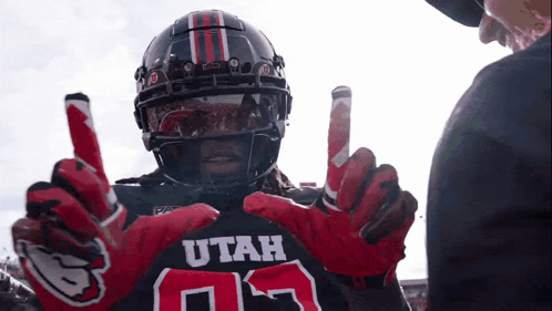 Football Player in Utah Jersey and Gloves Talks to Referee