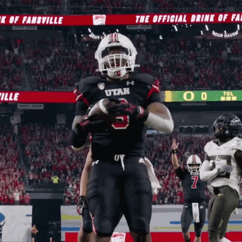 Football Player in Utah Jersey Holding Football