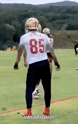Football Player in White Jersey Number 85 on Field