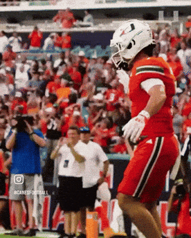 Football Player Jumping in Red Jersey