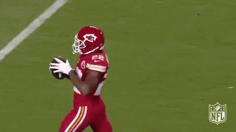 Football Player Jumping to Catch Ball