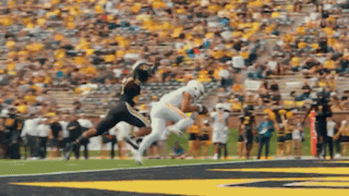 Football Player Jumping to Catch Ball