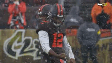 Football Player Kicking Ball in Snow