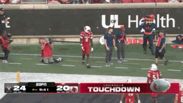 Football Player Kneeling on Field
