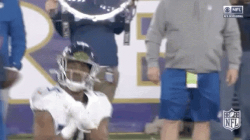 Football Player Kneeling With Cameraman Behind GIF