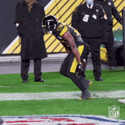 Football Player Kneeling With NFL Logo