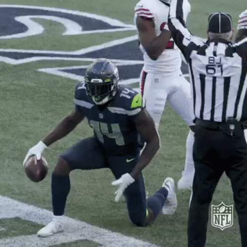 Football Player Kneeling With Referee