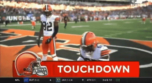 Football Player Kneeling With Touchdown Sign