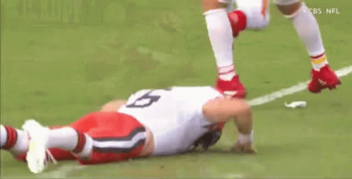 Football Player Laying On Field Head Down GIF